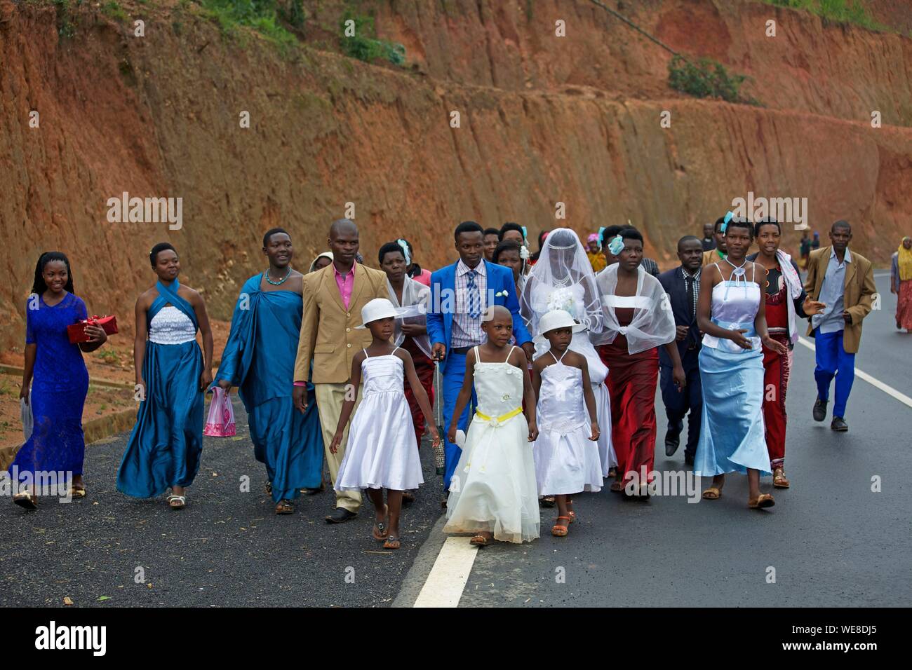 Rwanda, center of the country, married and their guests walking on the road Stock Photo