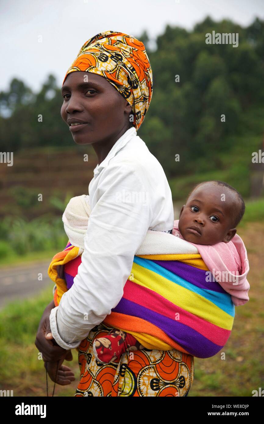 Rwanda, Gisakura, woman wearing a colorful turban and carrying her baby in the back Stock Photo