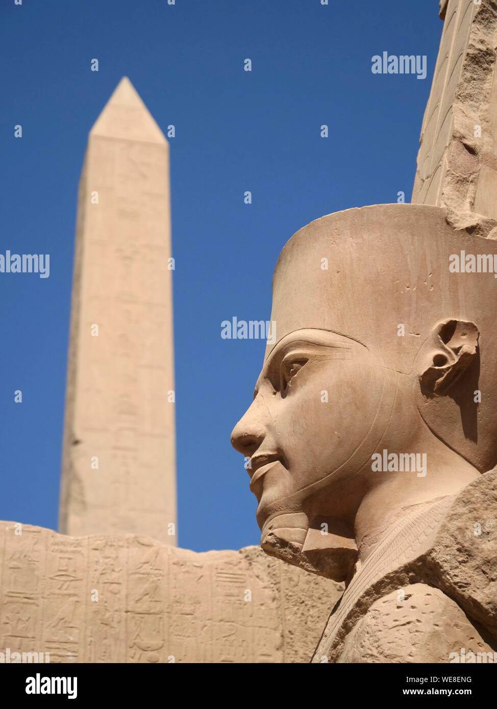 Egypt, Upper Egypt, Nile Valley, Luxor, Karnak World Heritage Site, Temple dedicated to the god Amun, Obelisk and Tutankhamen statue Stock Photo