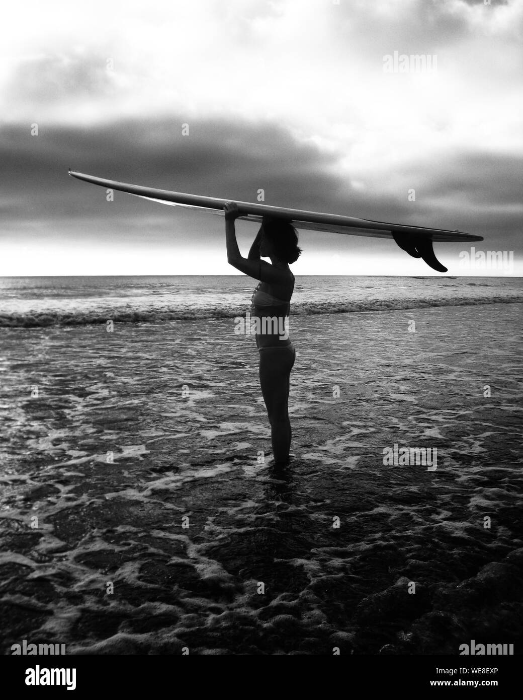 Woman Carrying Surfboard Black and White Stock Photos & Images - Alamy