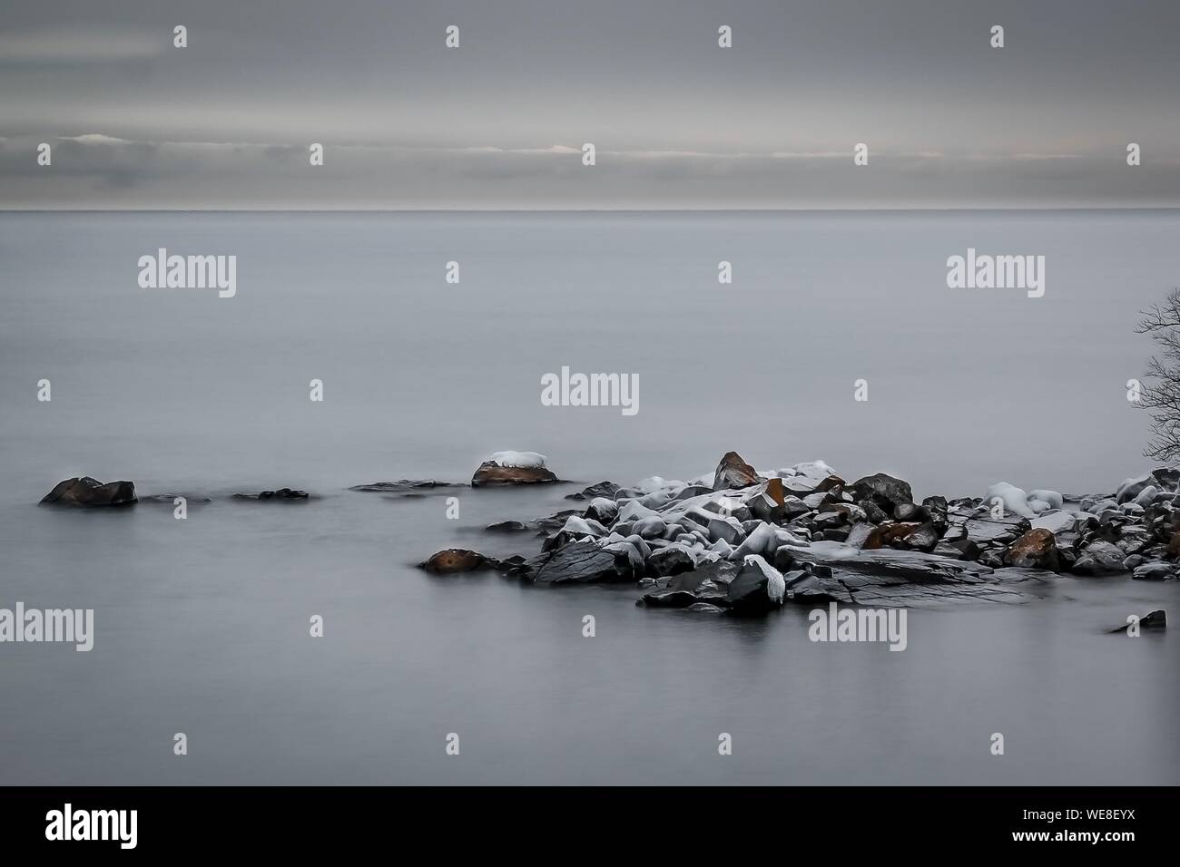 Scenic View Of Lake Superior Against Sky During Winter Stock Photo