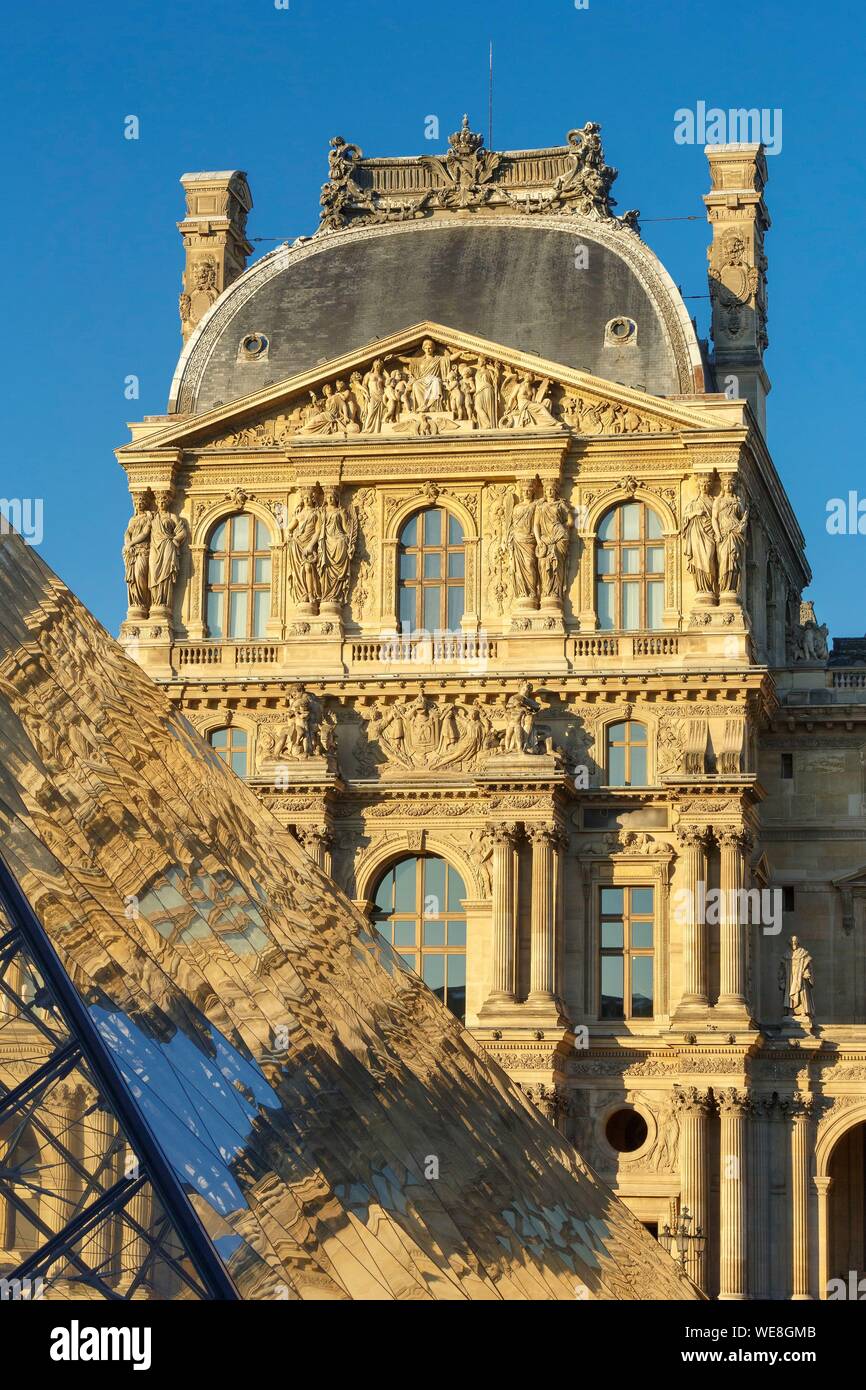 France, Paris, area listed as World Heritage by UNESCO, reflection of the facade of the Richelieu Wing on the pyramid of the Louvre by the architect Ieoh Ming Pei in the Cour Napoleon Stock Photo