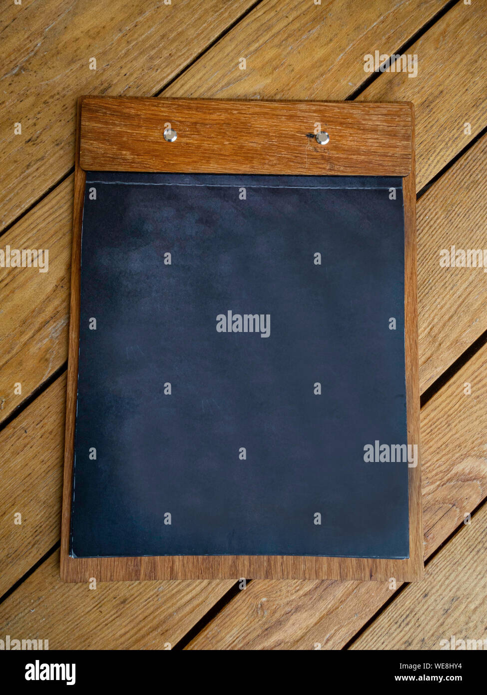 Blackboard on wooden surface with copy space Stock Photo