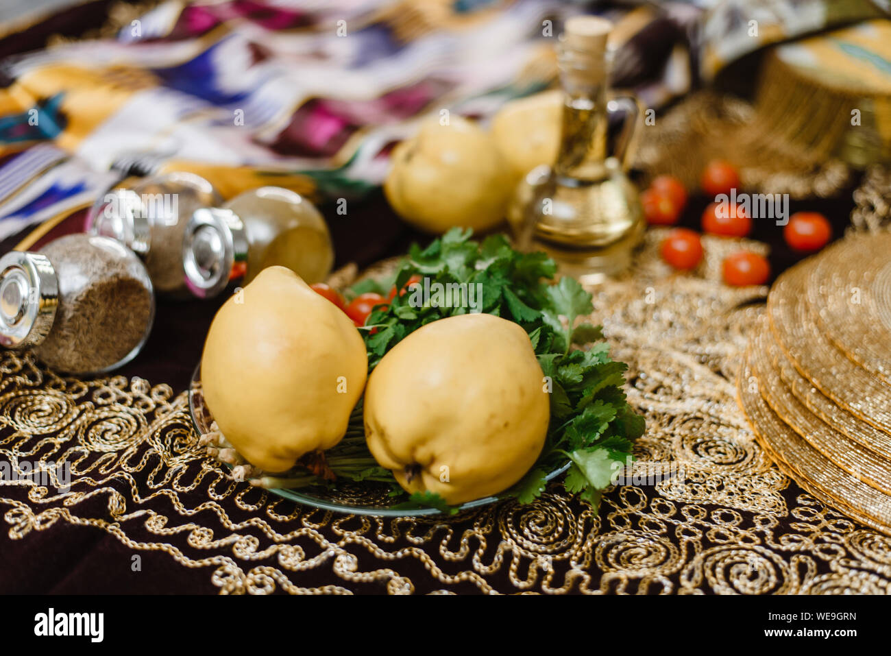 Quince Fruits On A Table Decorated With Oriental Fabrics With