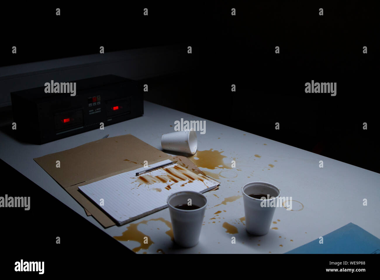 Police Custody Interview Room - Spilled Coffee Following a Confrontation Stock Photo