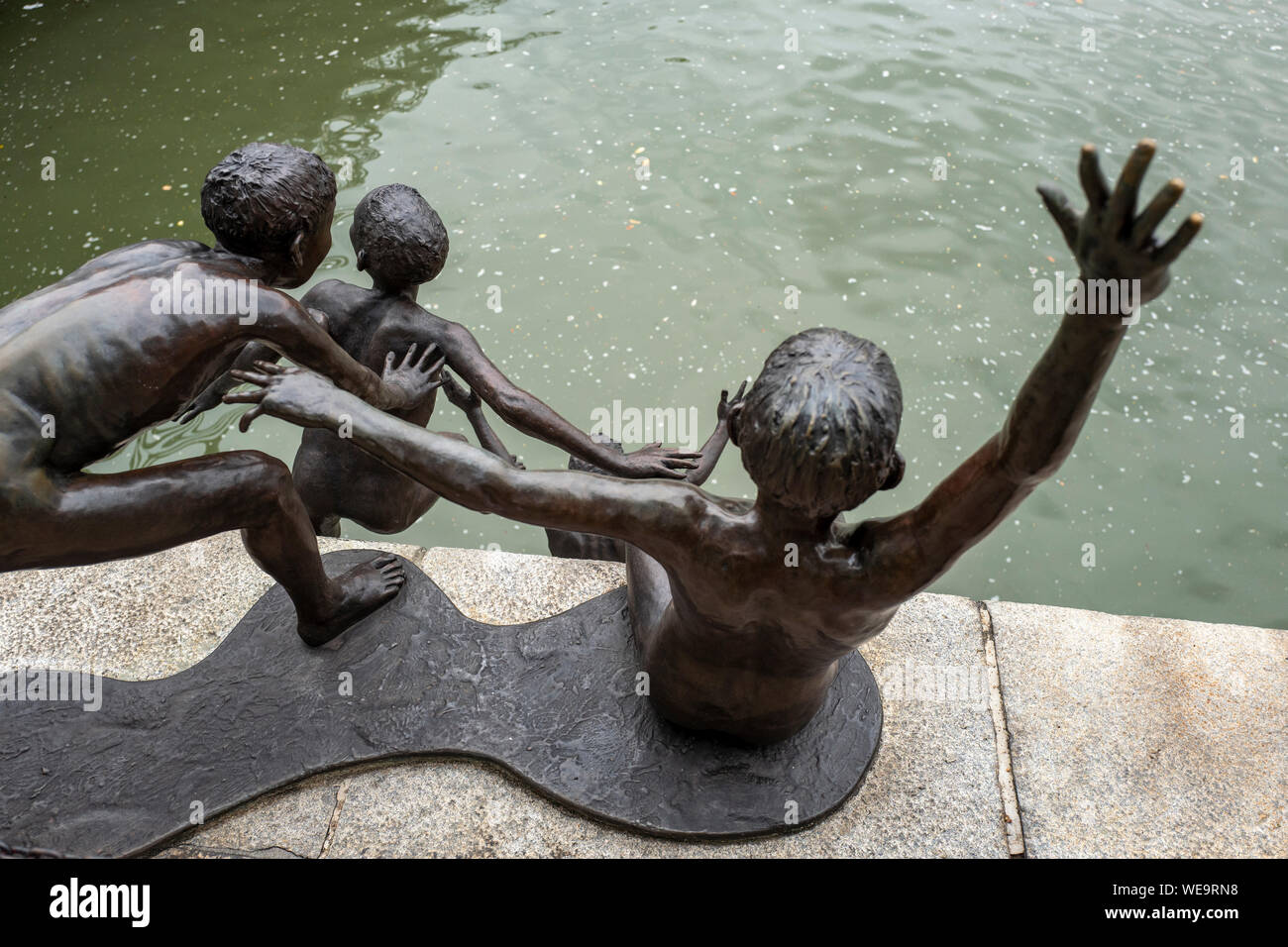 First Generation bronze sculptures as part of the People of the River series by artist Chong Fah Cheong on the Singapore River, Singapore Stock Photo