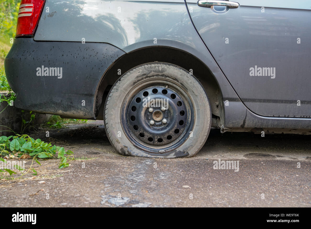 car wheel flat tire on the road Stock Photo Alamy