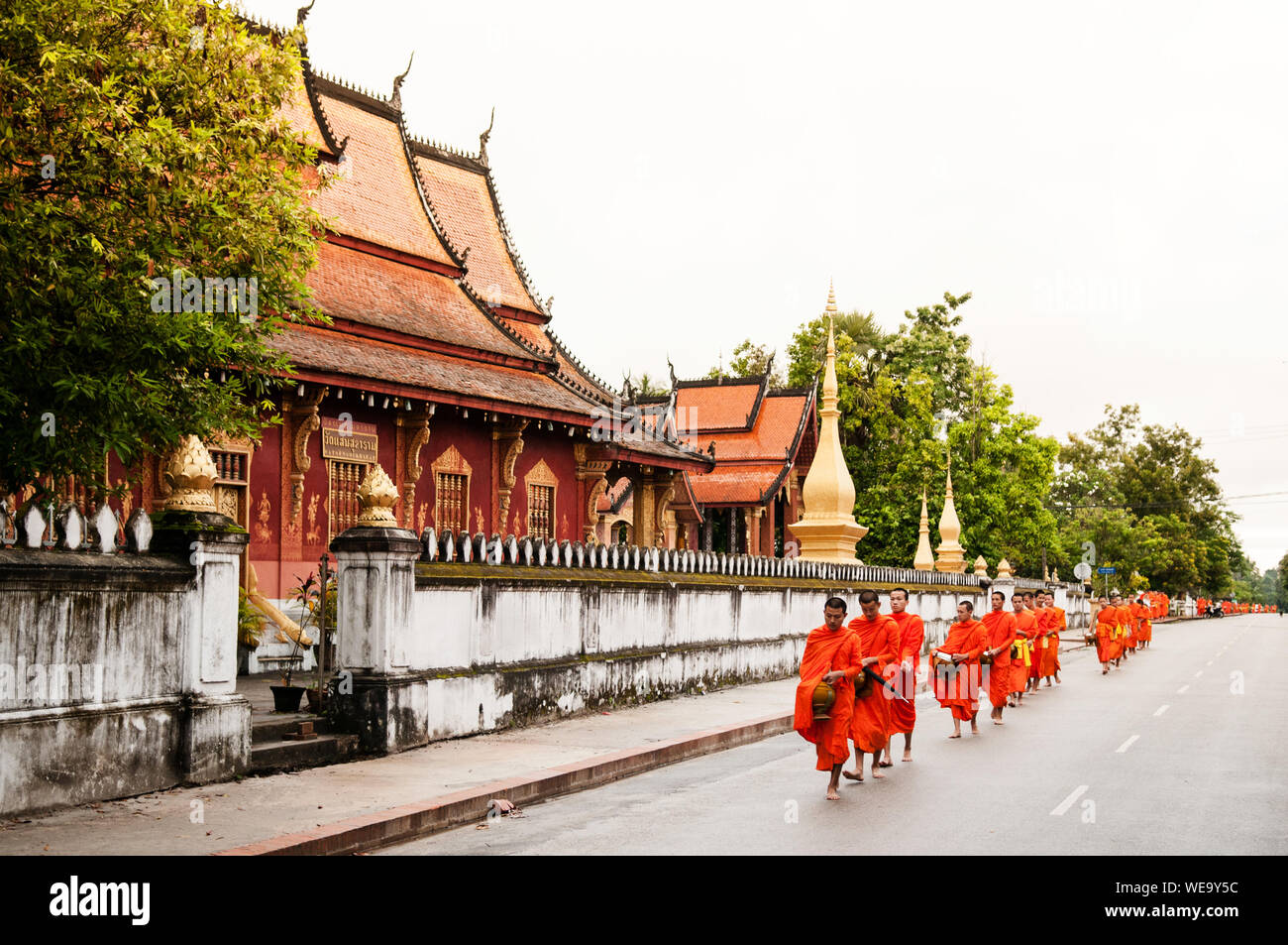 Sep 6, 2011 Luang Prabang, Laos : Traditional Alms giving ceremony of distributing food to buddhist monks on the streets Stock Photo