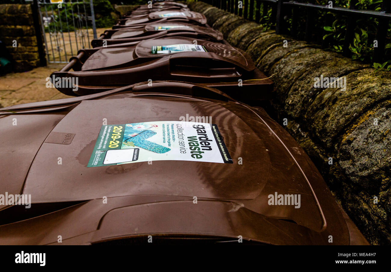 A line of brown garden waste wheelie bins outside a community garden Stock Photo Alamy
