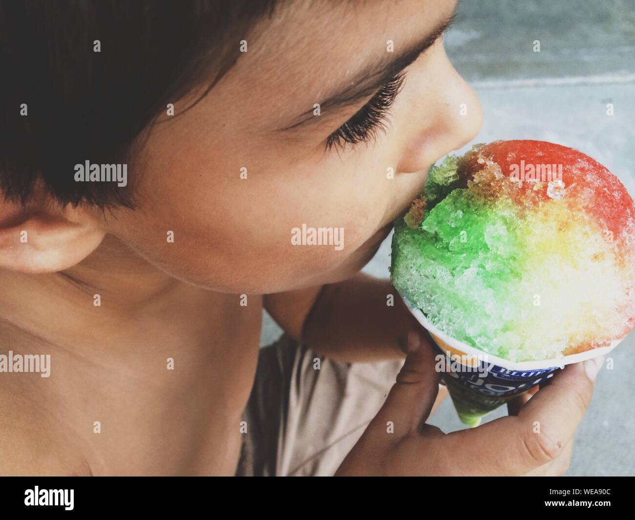 Download High Angle View Of Shirtless Boy Eating Colorful Ice Cream Stock Photo Alamy Yellowimages Mockups