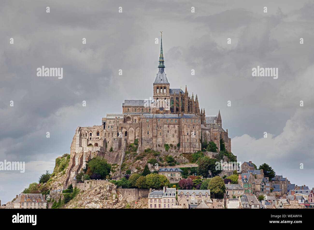 Low Angle View Of Mont Saint Michel Abbey Against Cloudy Sky Stock Photo