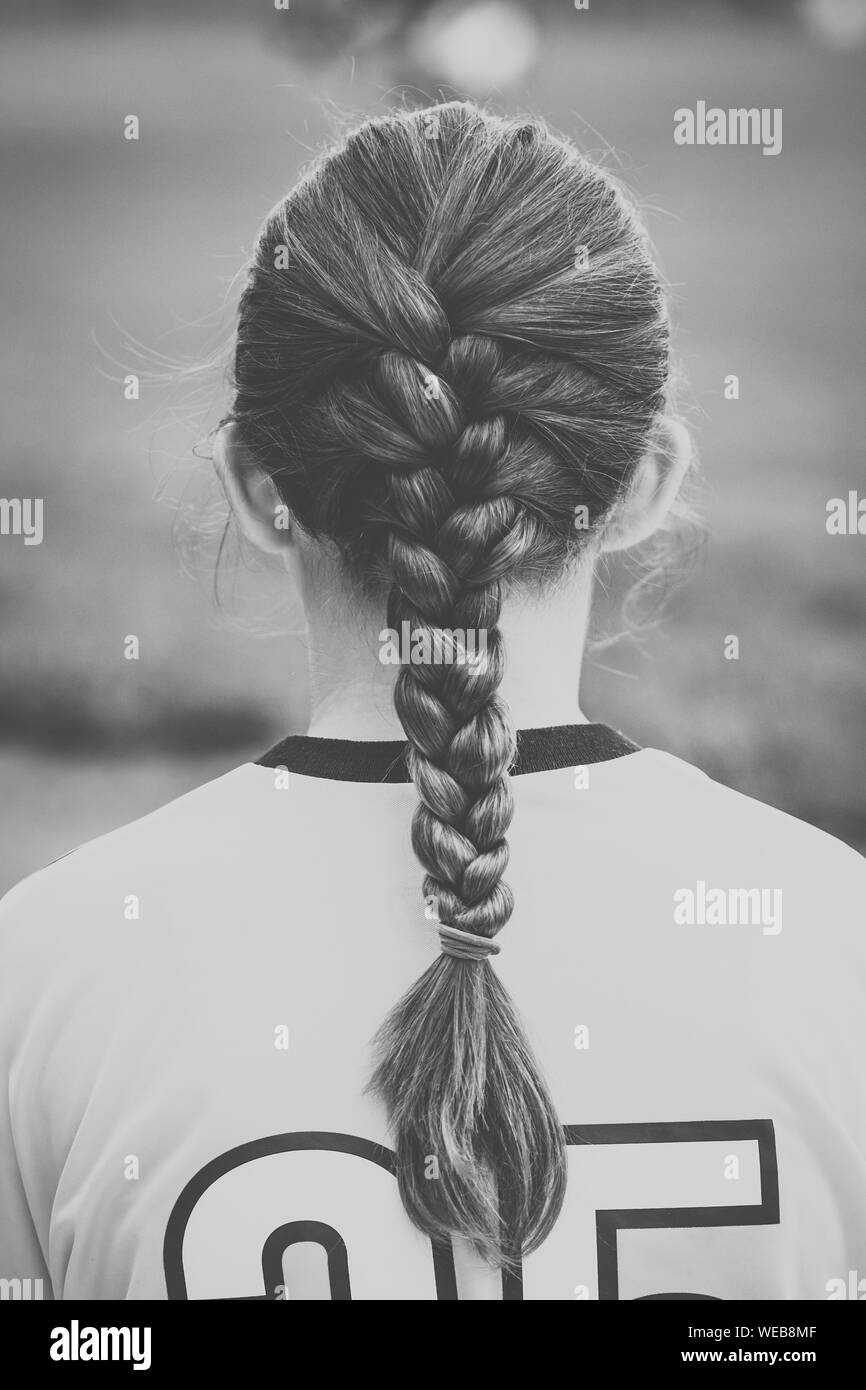 Rear View Of Female Soccer Player With Braided Hair Stock Photo