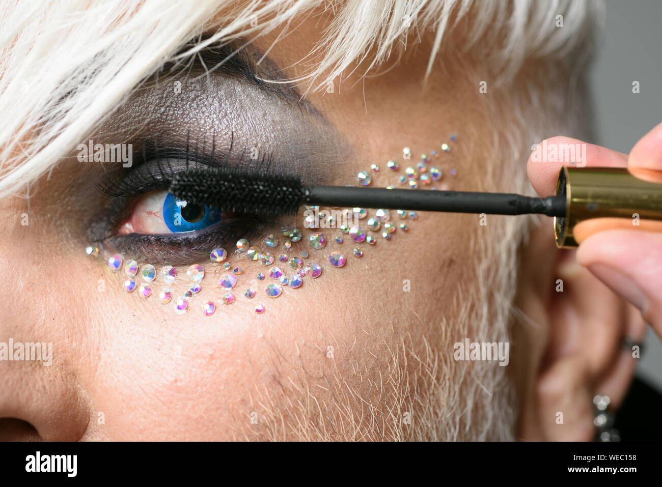 Im addicted to long eyelashes. Transgender man apply mascara. Male makeup  artist. Transgender man wear eyeshadows and eyebrow makeup. Male makeup  look Stock Photo - Alamy