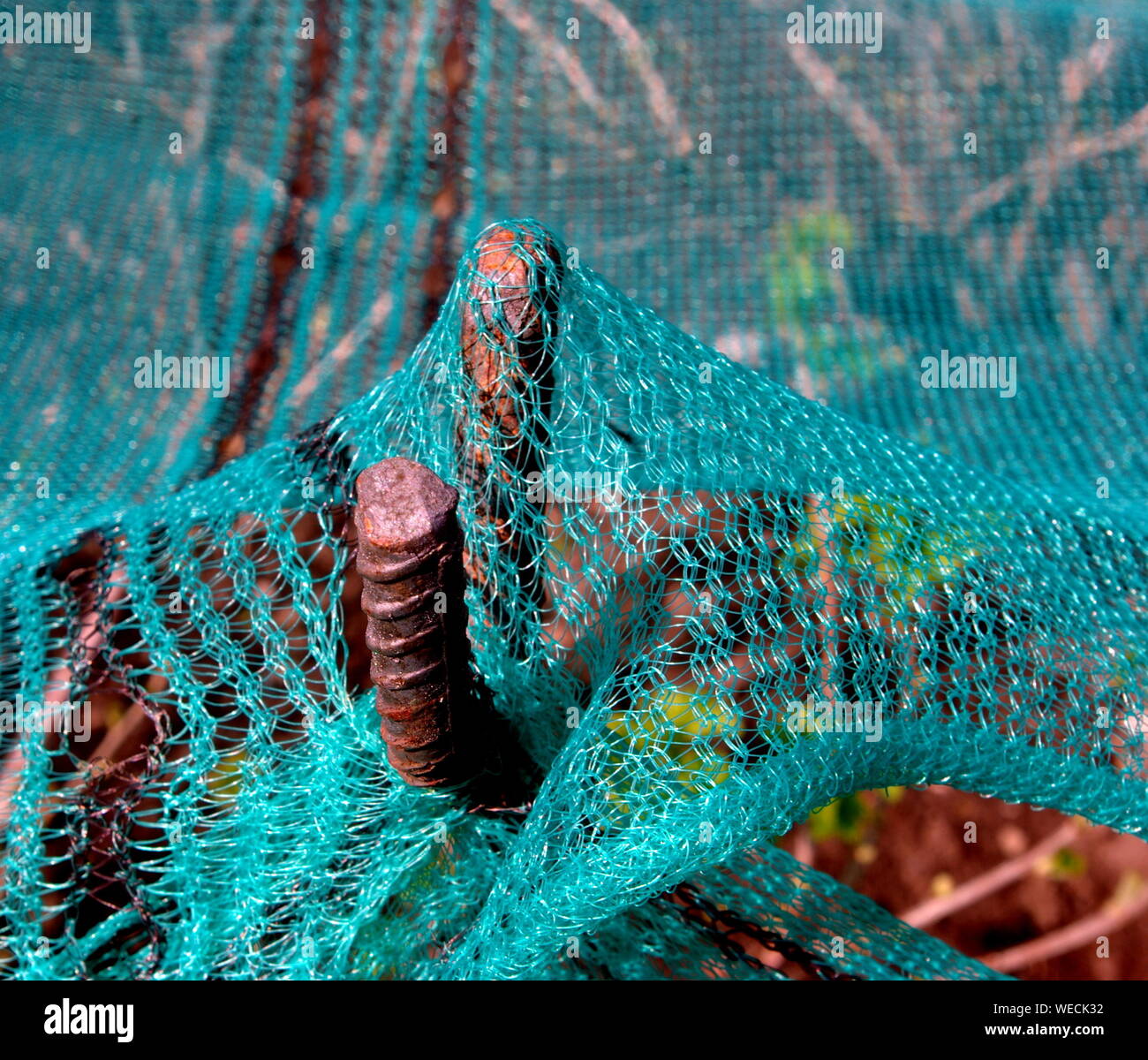 Close-up Of Fishing Net And Iron Rod Stock Photo