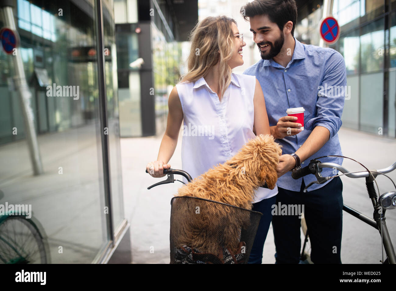 Couple in love with dog walking and smiling outdoor Stock Photo - Alamy