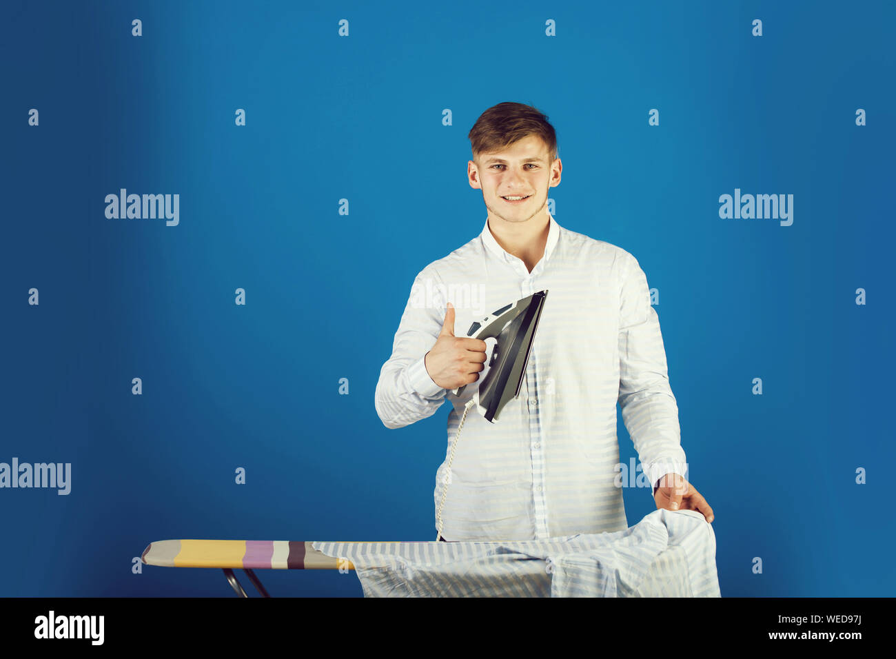 Guy using iron Stock Photo - Alamy