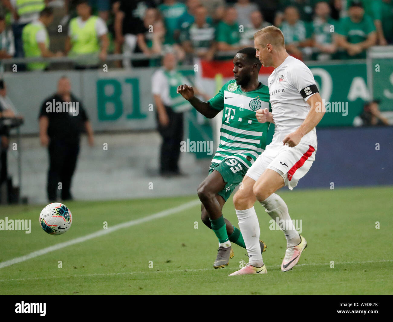 BUDAPEST, HUNGARY - AUGUST 29: (l-r) Tokmac Chol Nguen of Ferencvarosi TC competes for the ball with Algis Jankauskas of FK Suduva during the UEFA Europa League Play-off Second Leg match between Ferencvarosi TC and FK Suduva at Ferencvaros Stadium on August 29, 2019 in Budapest, Hungary. Stock Photo