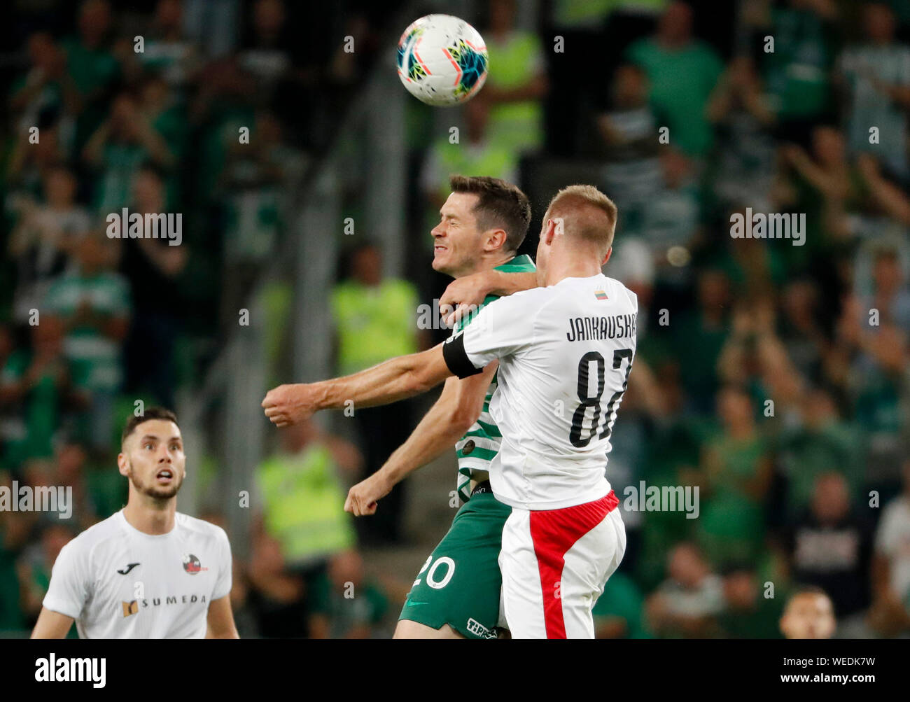 BUDAPEST, HUNGARY - AUGUST 29: (r-l) Algis Jankauskas of FK Suduva battles for the ball in the air with Nikolai Signevich of Ferencvarosi TC before Jovan Cadjenovic of FK Suduva during the UEFA Europa League Play-off Second Leg match between Ferencvarosi TC and FK Suduva at Ferencvaros Stadium on August 29, 2019 in Budapest, Hungary. Stock Photo