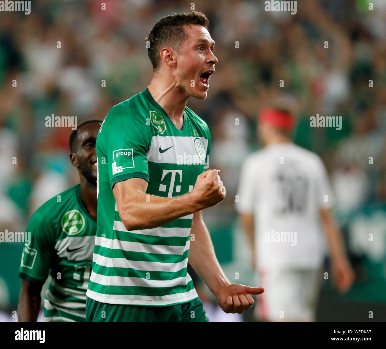 BUDAPEST, HUNGARY - AUGUST 13: (l-r) Tokmac Chol Nguen of Ferencvarosi TC  wins the ball from Arijan Ademi of GNK Dinamo Zagreb during the UEFA  Champions League Third Qualifying Round match between