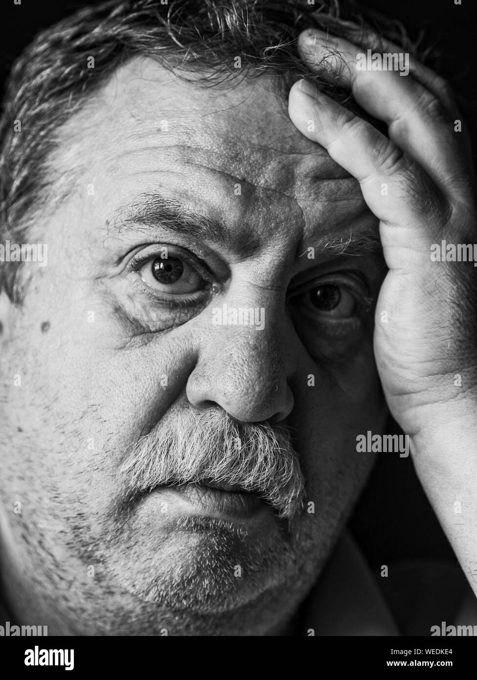 Close-up Portrait Of Worried Senior Man Stock Photo
