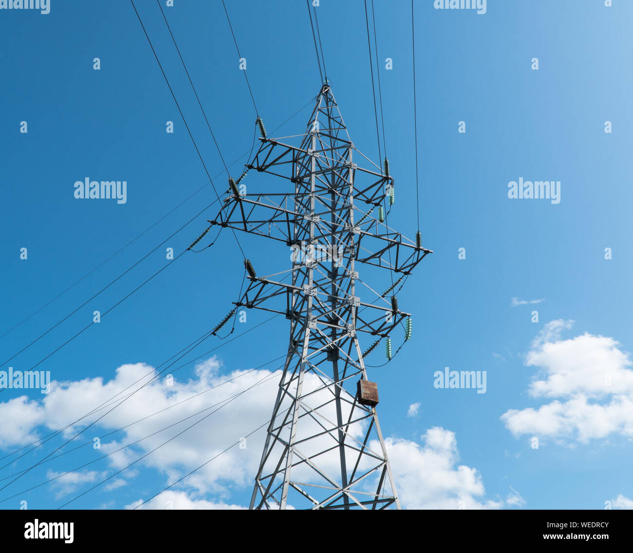 high voltage tower against the blue sky and clouds Stock Photo - Alamy