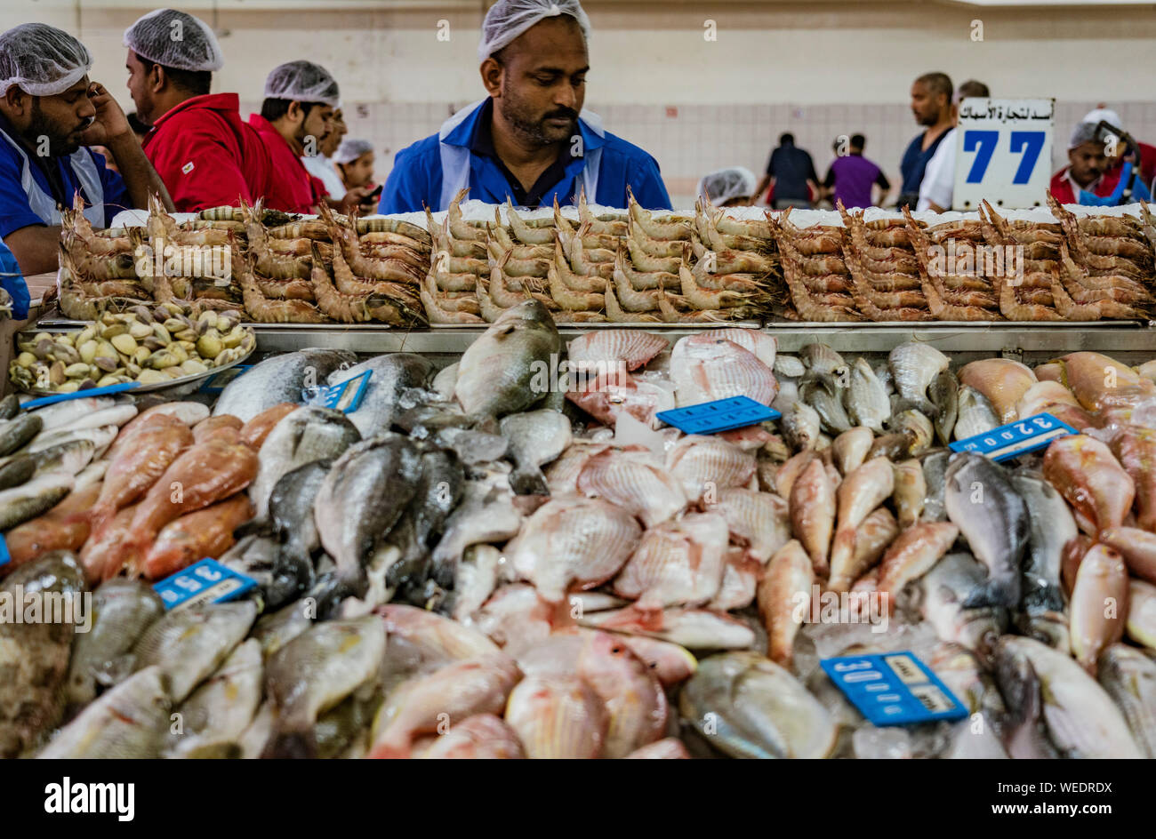 ABU DHABI, UAE, MAR 22, 2018 Man prepares fish for sale at the largest