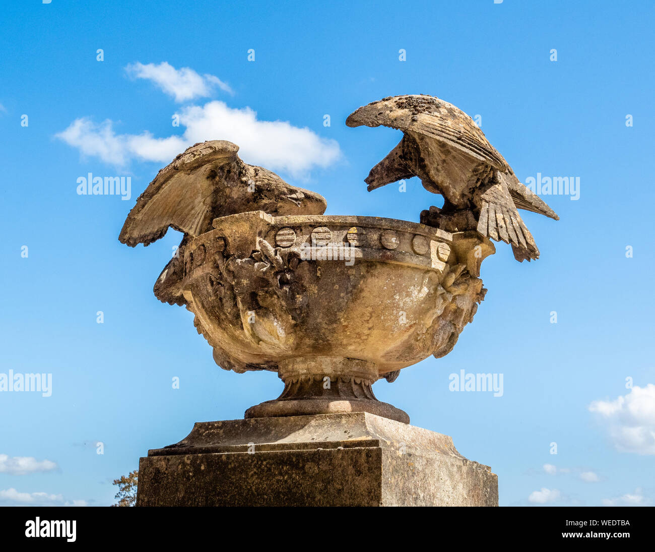 One of the stone basins with squabbling eagles perched on the rim flanking the portico to Stourhead House in Wiltshire UK Stock Photo