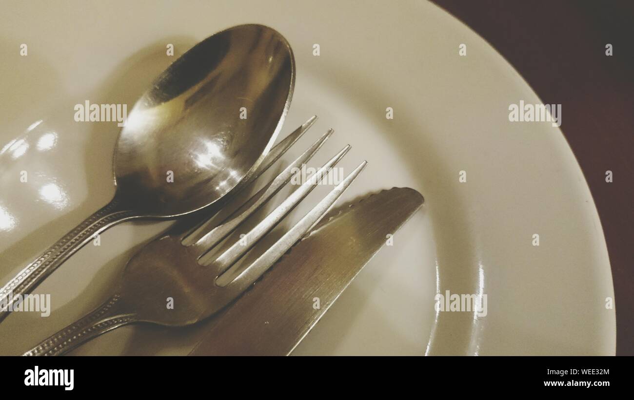 Close-up Of Silverware On Plate Stock Photo