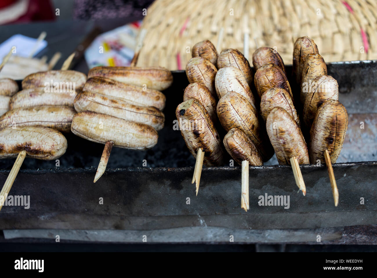 Delicious Vietnamese dessert grilled banana stick in street food market