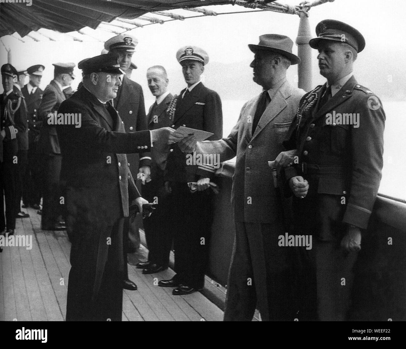Winston Churchill aboard American ship,Augusta meeting with President Roosevel and handing Roosevelt a letter from HM George V1. 9th August 1941 Stock Photo