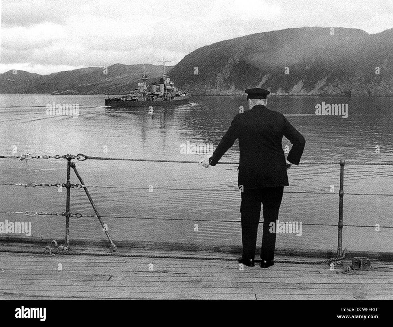 Winston Churchill aboard HMS Prince of Wales visiting Newfoundland for meeting with President Roosevelt. .Churchill watches the departure of Augusta Stock Photo