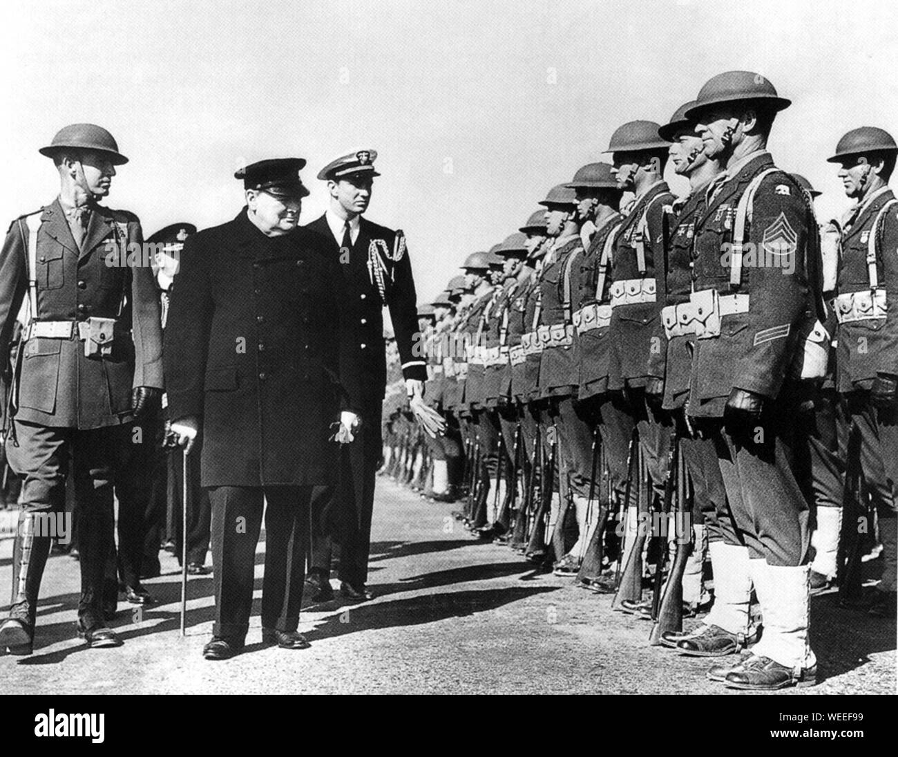 Winston Churchill  inspecting American marines in Iceland during his return from the meeting with President Roosevelt at Newfoundland. August 1941 Stock Photo
