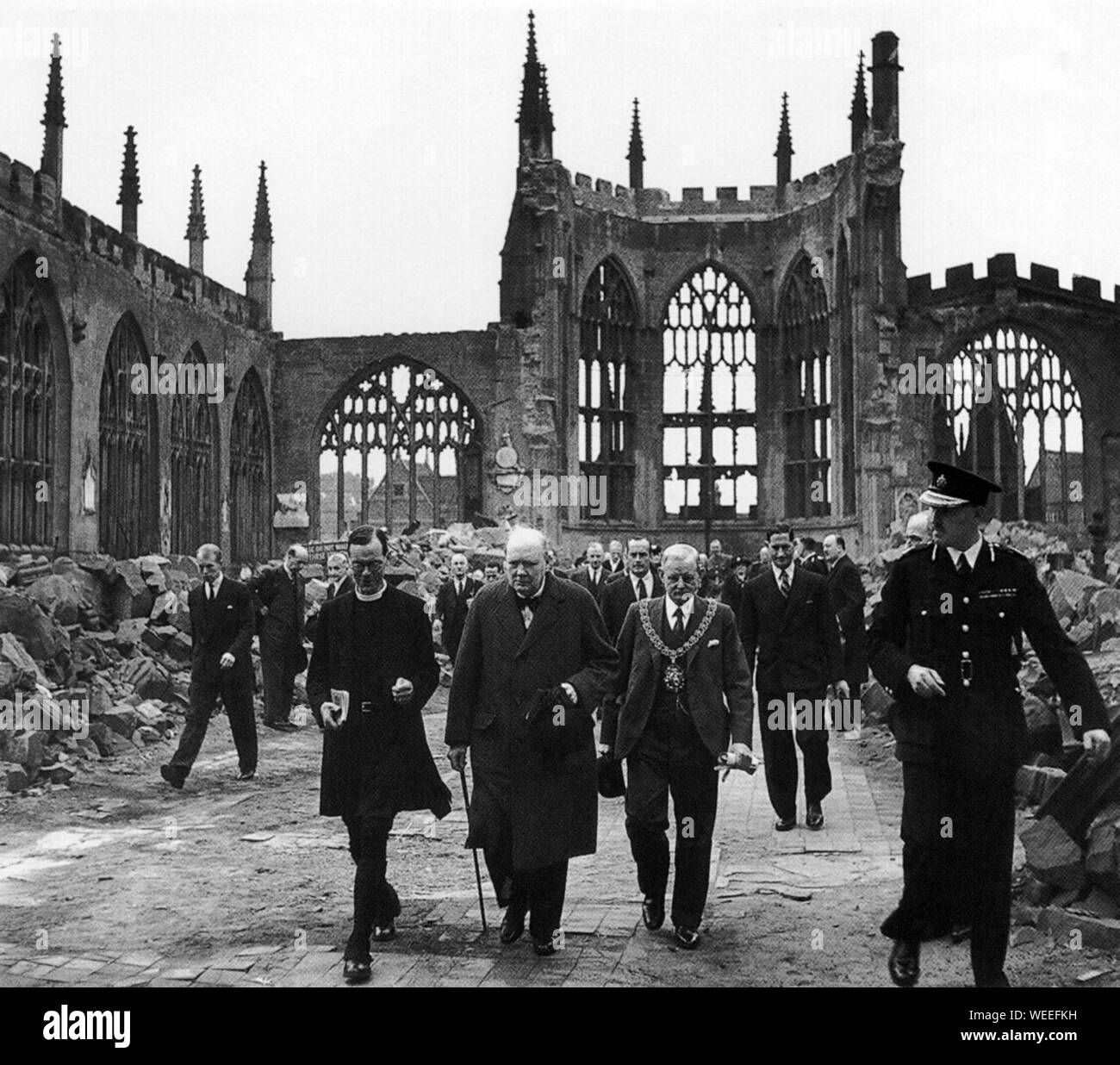 Winston Churchill visits bomb damaged cities. Here he views the shell of Coventry Cathedral, wrecked by German bombs. 28th September 1941 Stock Photo