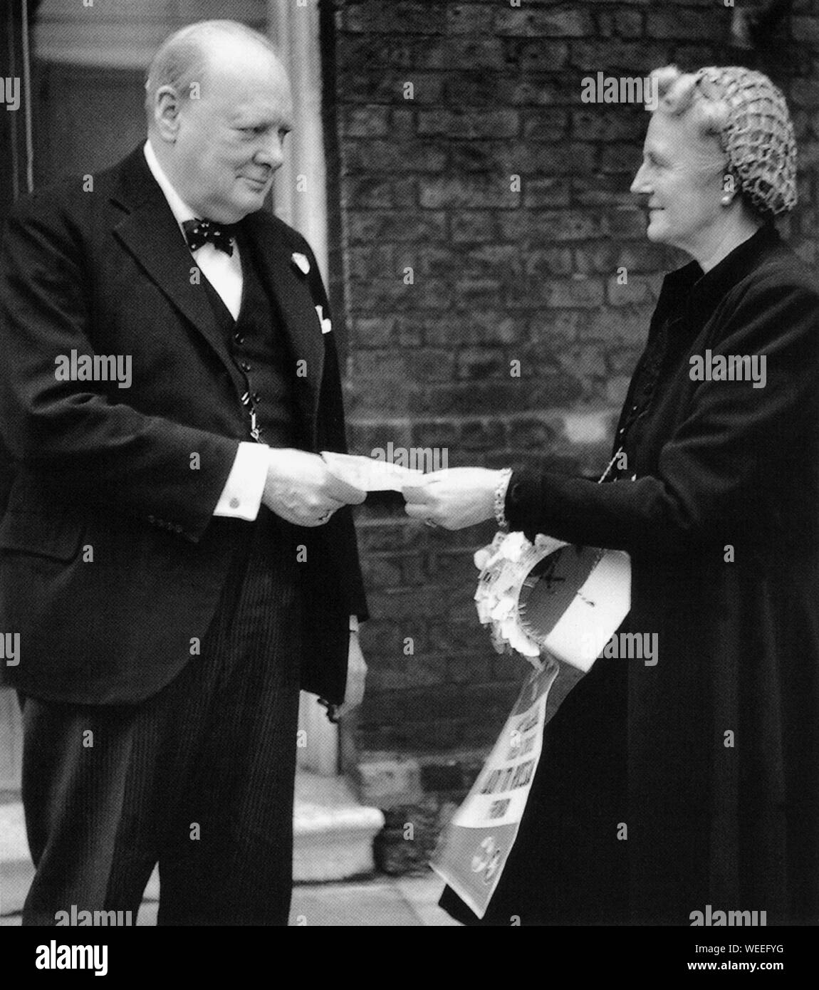 Winston Churchill donating money to Mrs Churchill's Red Cross Aid to Russia Appeal. December 1941 Stock Photo