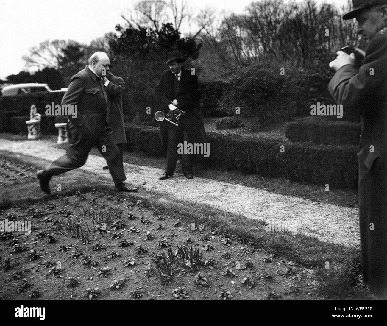 Winston Churchill wearing his trademark 'siren suit' in the White House garden. December 1941 Stock Photo