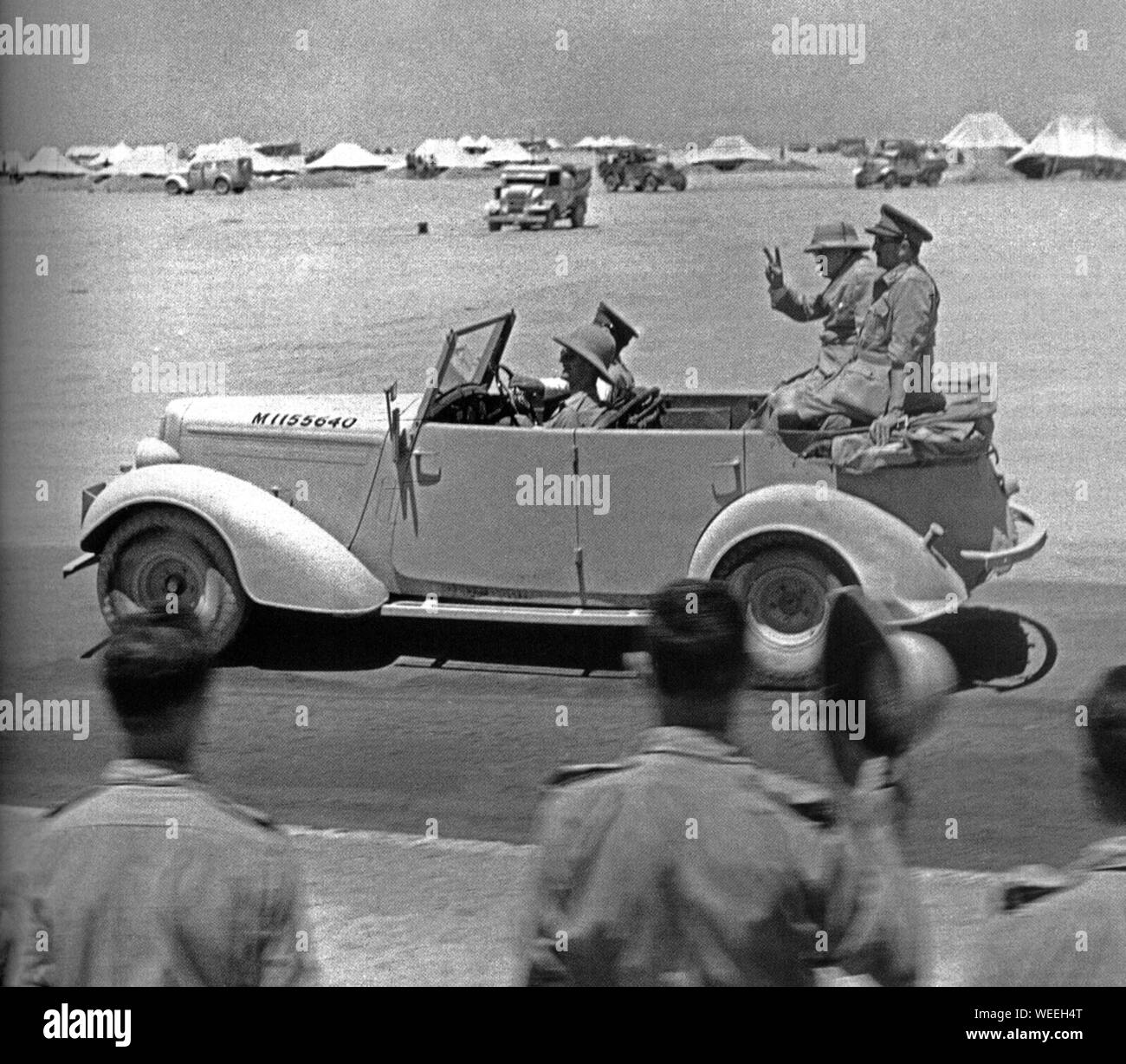 Winston Churchill in staff car with General Sir Alan Brooke giving victory salute to troops in the Western Desert. 23 August 1942 Stock Photo