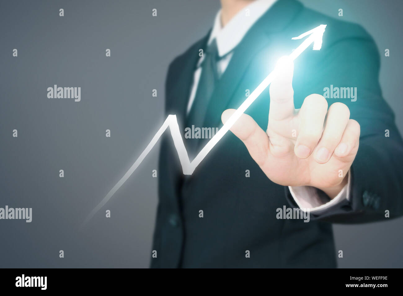 Businessman Hand Touching stock Graph Indicating Growth Stock Photo - Alamy