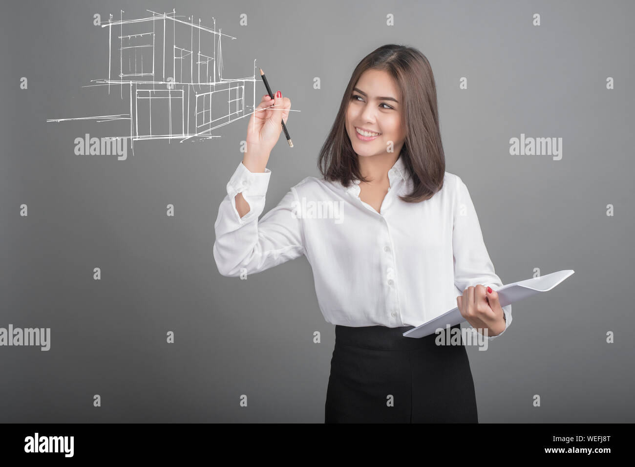 Digital Composite Image Of Architecture Drawing While Standing Against Gray Background Stock Photo