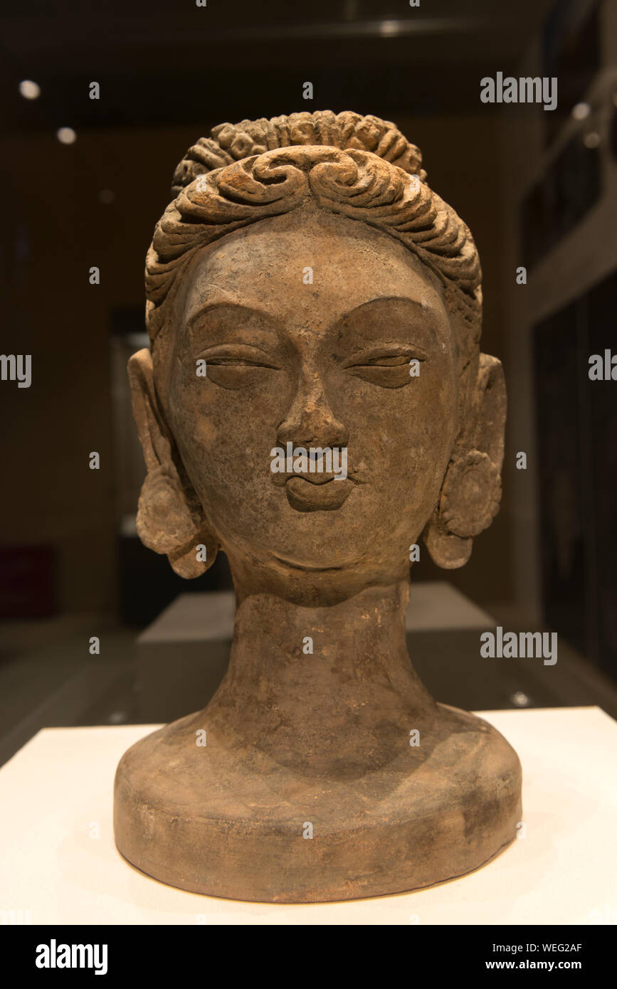 Painted sculpture of a Buddha's head. Xikeqin Thousand Buddha Caves in Yanqi County, Xinjiang. National Museum of China. Stock Photo
