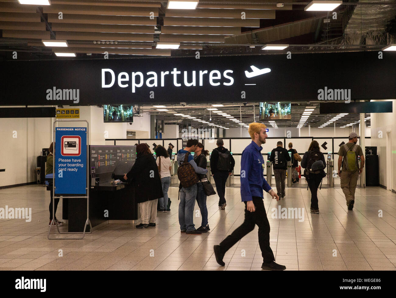 Departures gate at Luton Airport. People departing and saying farewell ...