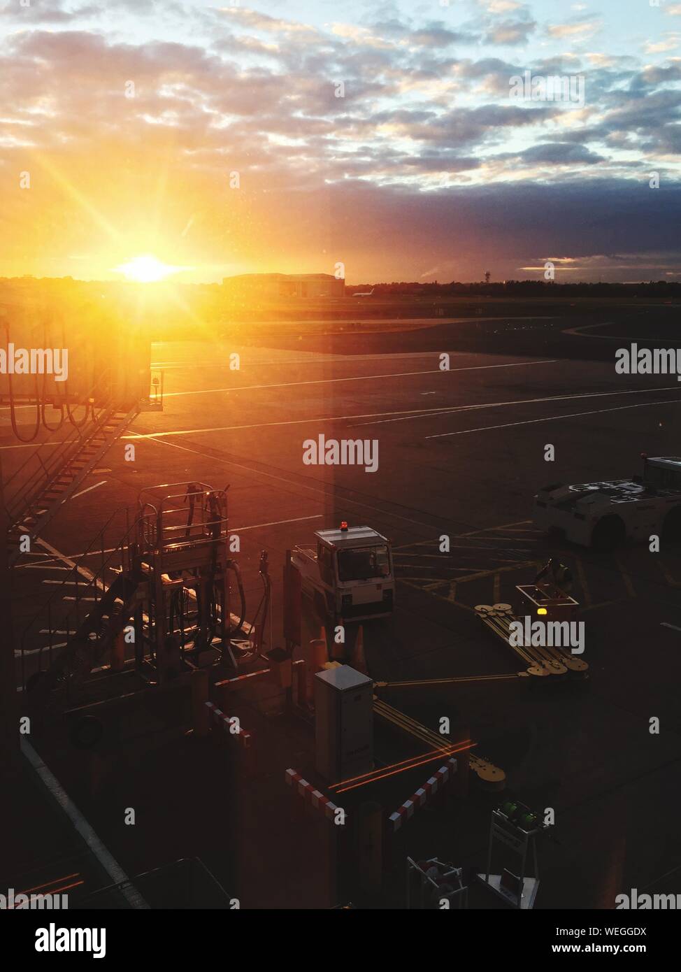 Sunlight On Birmingham Airport Runway Against Sunset Sky Stock Photo