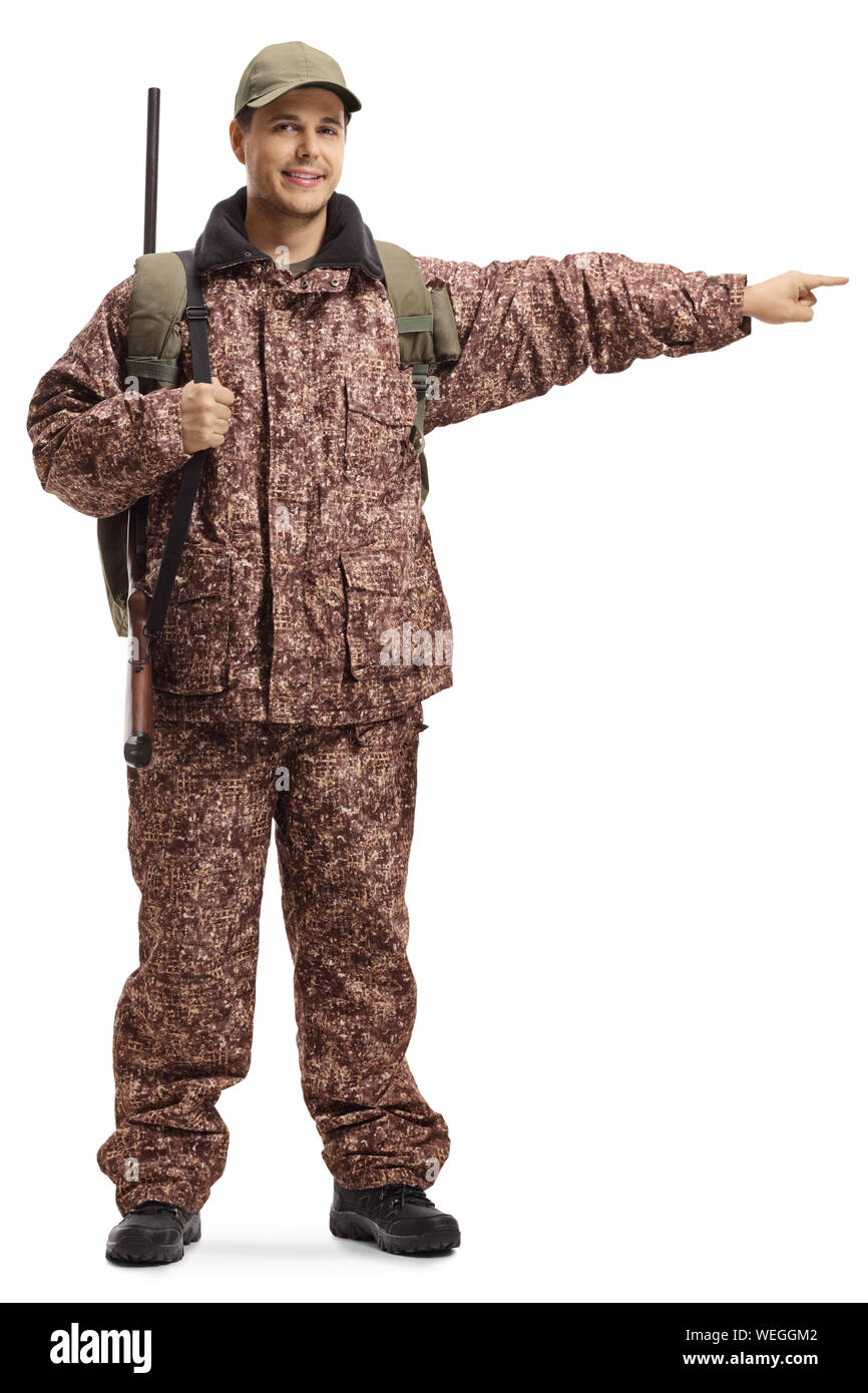 Full length portrait of a soldier with a shotgun pointing to the side isolated on white background Stock Photo
