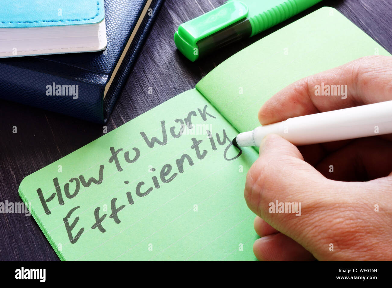 Man is writing How to Work efficiently. Stock Photo
