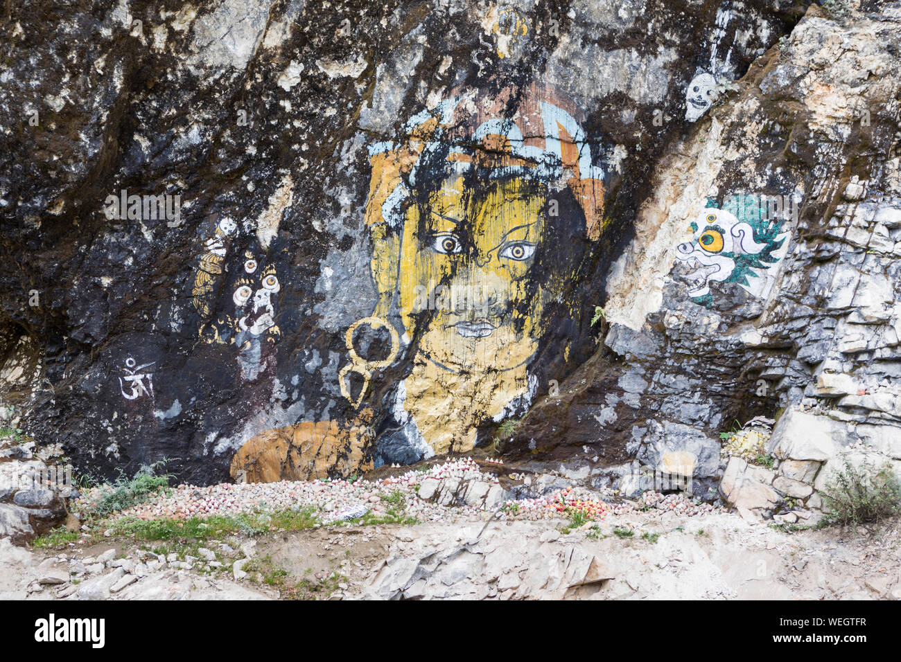Buddhist art murals on rocks by roadside in Central Bhutan Stock Photo ...