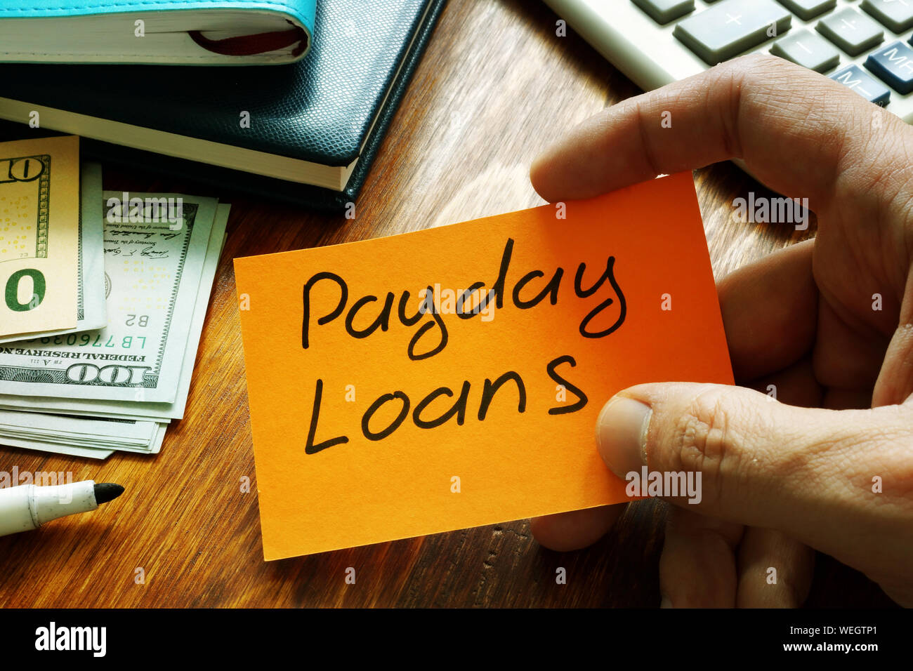 Payday loans written on a piece of paper. Stock Photo