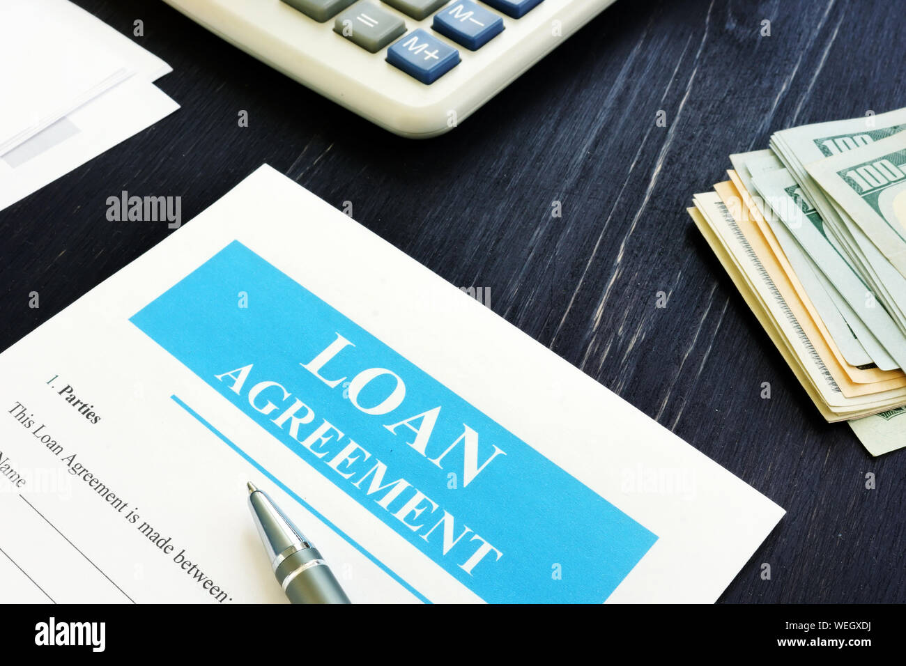Loan Agreement form with cash and calculator. Stock Photo