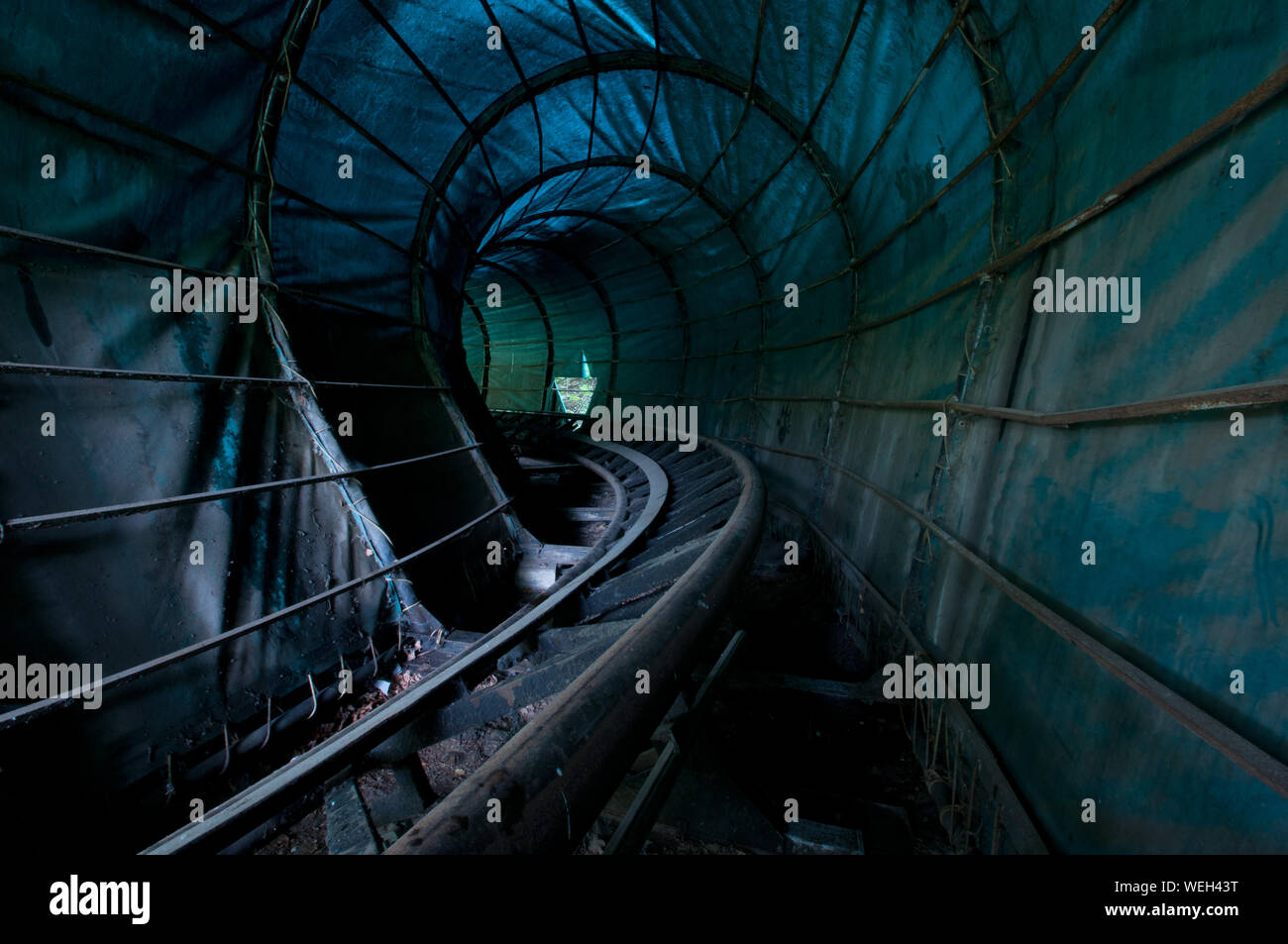 Railroad Tracks In Illuminated Tunnel Stock Photo