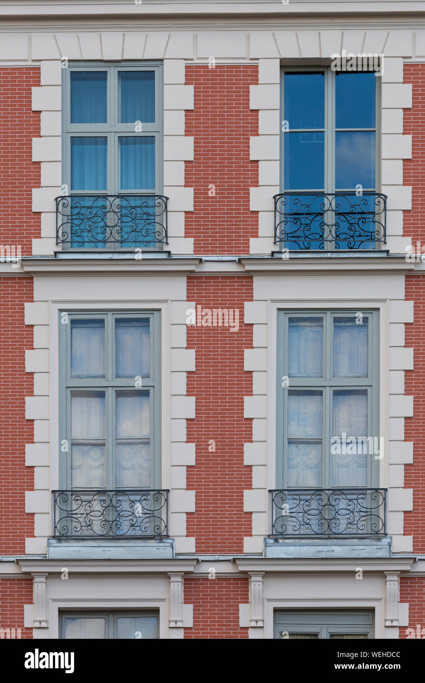 Facade with windows and balconies of apartment building in Paris, France Stock Photo