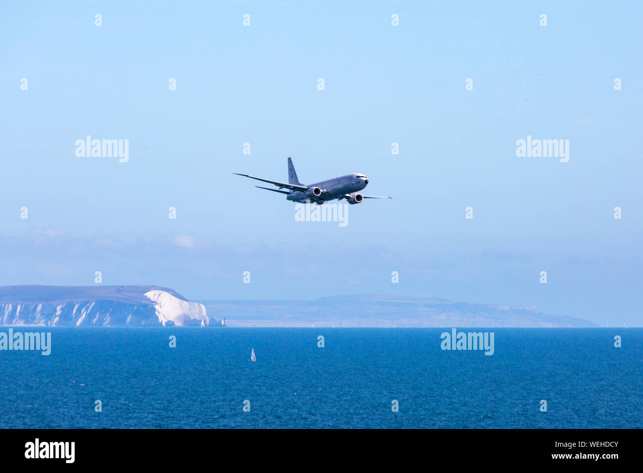 Bournemouth, Dorset UK. 30th August 2019. P-8A Poseidon Surveillance Aircraft - Boeing plane specifically developed for the US Navy and modified from the Boeing 737-800 does fly past at Bournemouth Air Festival with its wing span of nearly 40 meters, powered by two turbo fans. Showing the Isle of Wight and the Needles in the distance.  Credit: Carolyn Jenkins/Alamy Live News Stock Photo