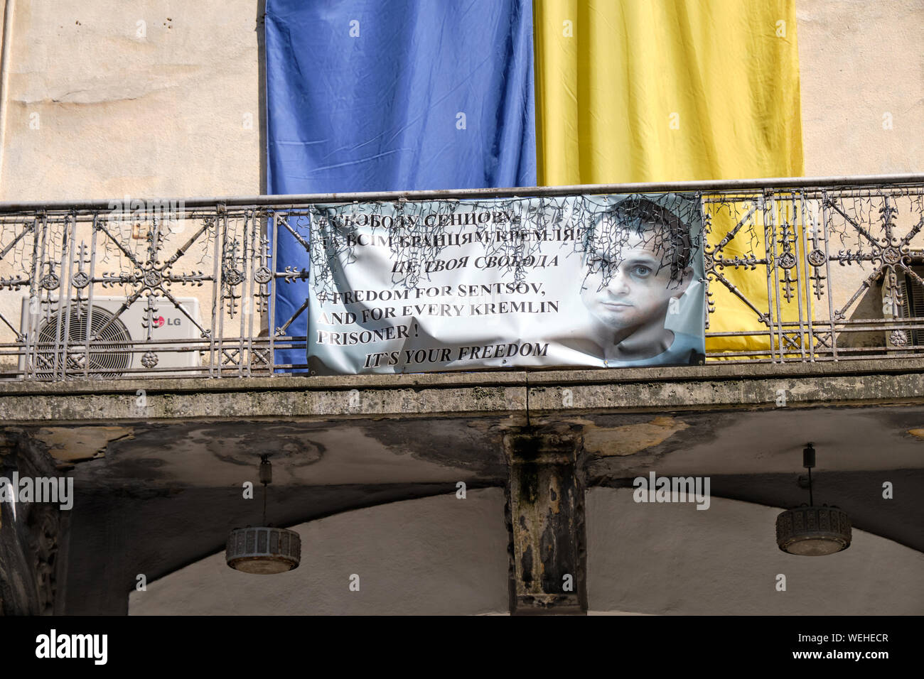 Lviv, Ukraine: Banner asking for freedom for Oleg Sentsov and other Kremlin Prisoner against Ukrainian Flag Stock Photo